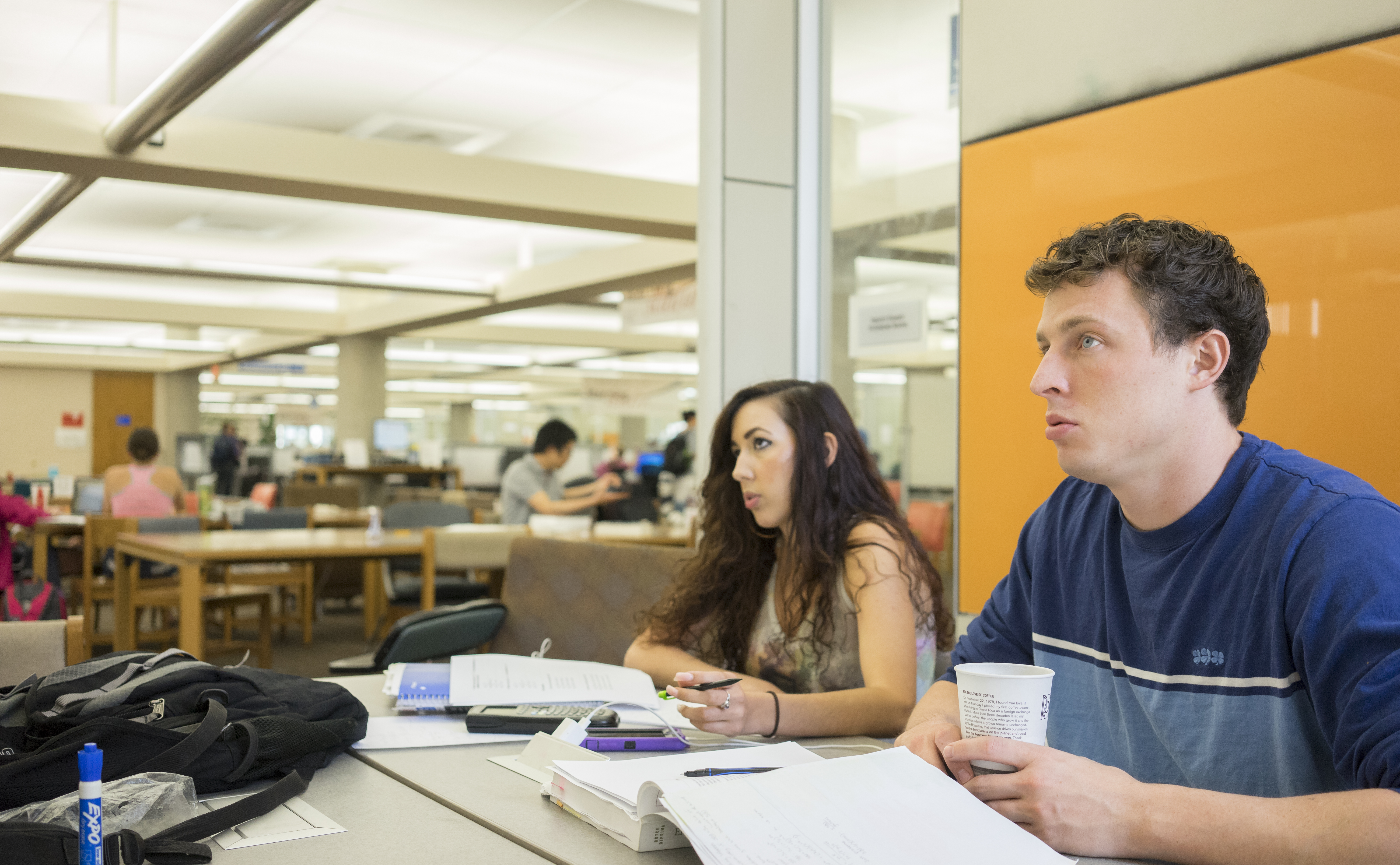 two students study together at a table in Anschutz Library
