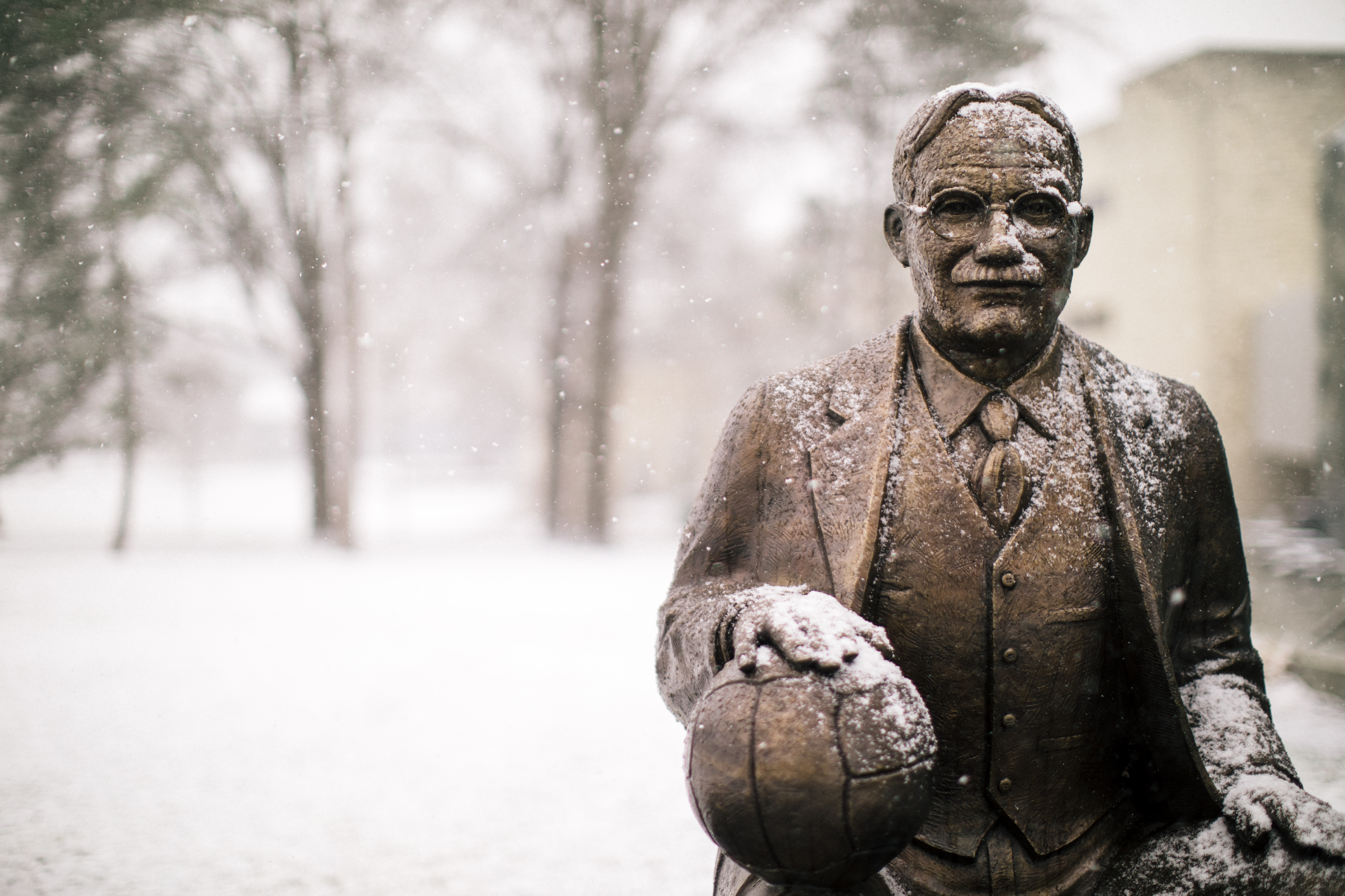 a statue of James Naismith outside of the DeBruce Center