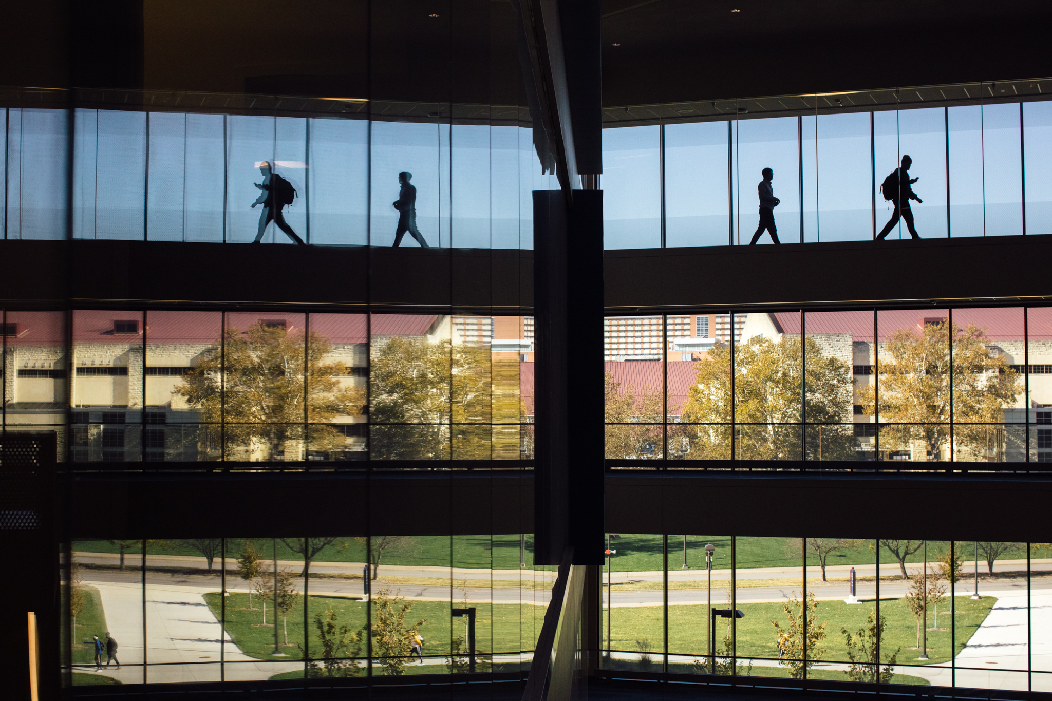silhouettes of students walking past the front windows of Capitol Federal Hall