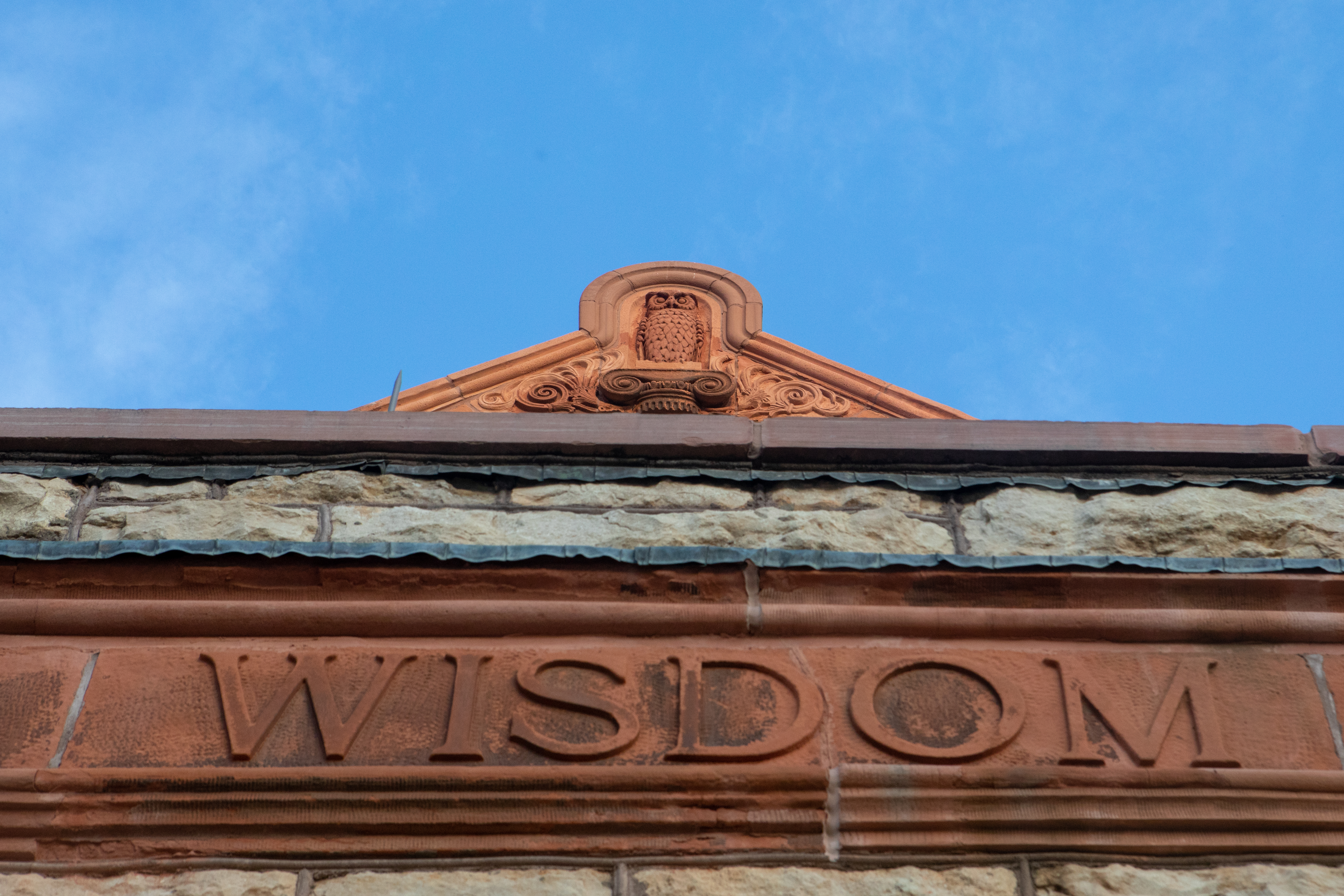 The front of Spooner Hall, with the sandstone owl at the top