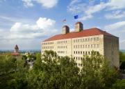 The American flag and KU flag fly atop the copulas of Fraser Hall