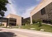 The two towers of the Earth, Energy & Environment Center connect at their base by a hallway of dark-tinted glass