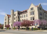 Redbud trees blooming and students walking past Snow Hall 