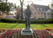 The Pioneer, the first sculpture on campus, sits on a base on the south side of Fraser Hall