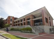 Two students walk in front of the Sabatini Multicultural Resource Center