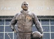 A dusting of snow on the Phog Allen statue with Booth Hall in the background