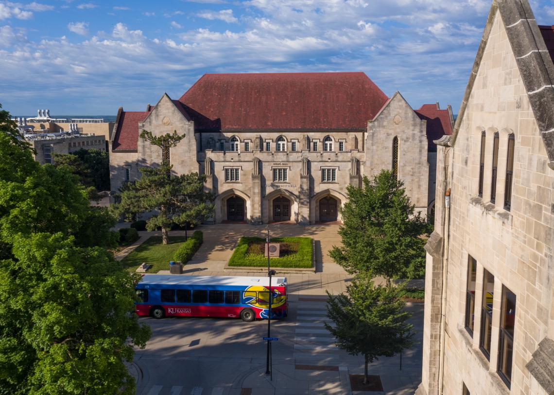 bus passing Budig Hall on Jayhawk Boulevard