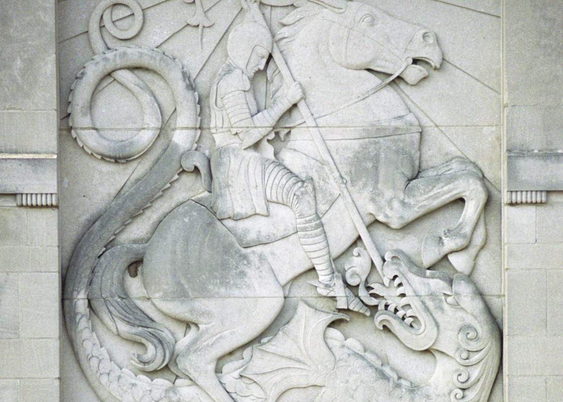 A close-up of a limestone relief of Saint George slaying a dragon