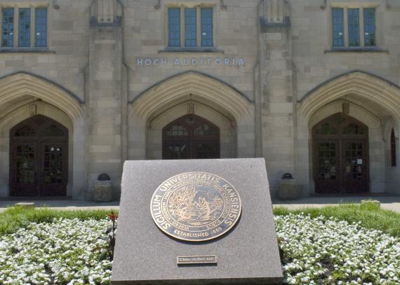 A bronze medallion of the University Seal sits in front of Budig Hall/Hoch Auditoria.