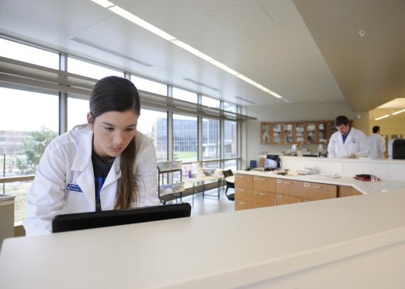 Two students work in a pharmacy skills lab