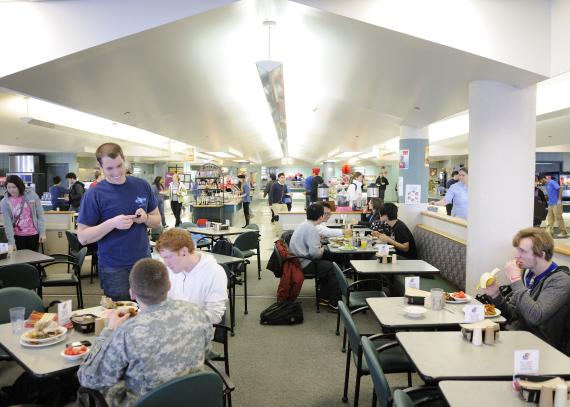 Students eat at tables in the dining hall