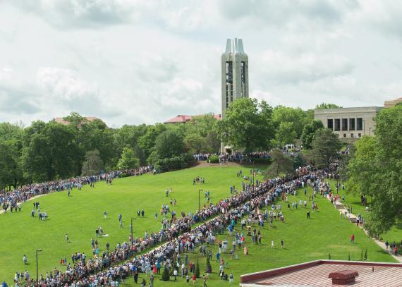 Students walk down the hill, from the Campanile to Memorial Stadium, during graduation