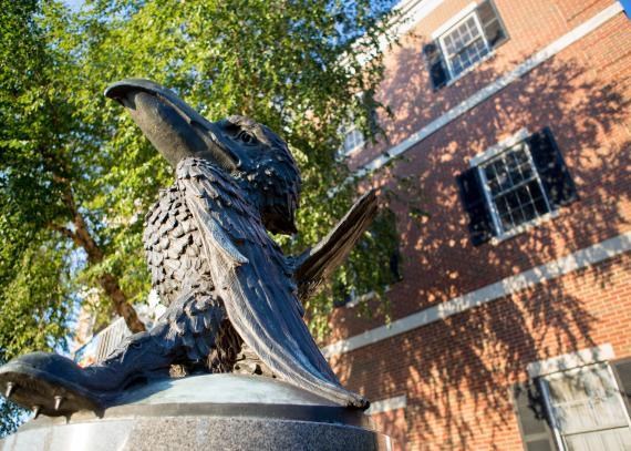 bronze Jayhawk sculpture on its granite base outside Adams Alumni Center
