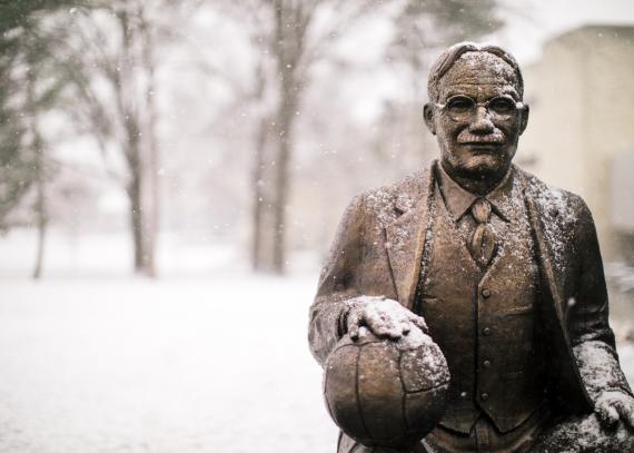 a statue of James Naismith outside of the DeBruce Center