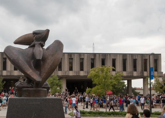 An exterior of Wescoe Hall, with students walking by during class change