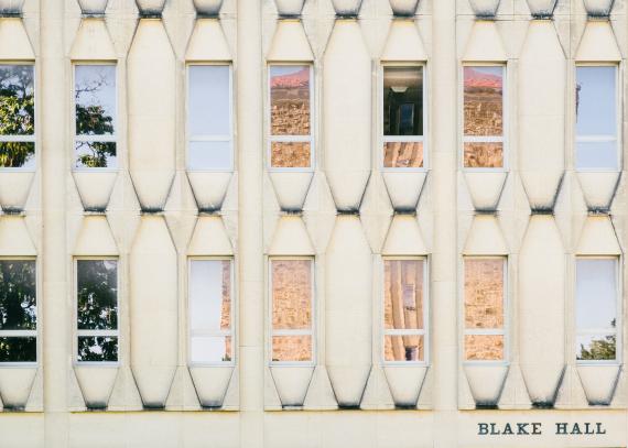 row of windows on Blake Hall reflecting Fraser Hall