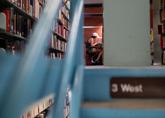 A student in the stacks at Watson Library