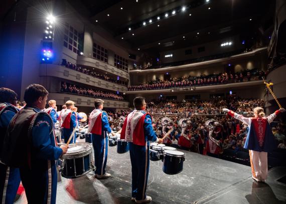 on-stage perspective of the KU Marching Band performing in the Lied Center Auditorium