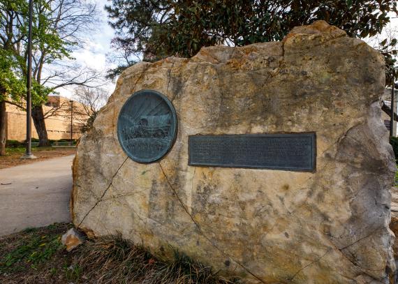 A limestone plinth commemorates the Oregon Trail on campus  