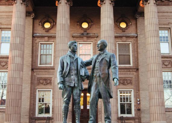 The Green Memorial, also known as the “Uncle Jimmy” statue, stands in front of Lippincott Hall on Jayhawk Boulevard and features James Woods Green mentoring a student
