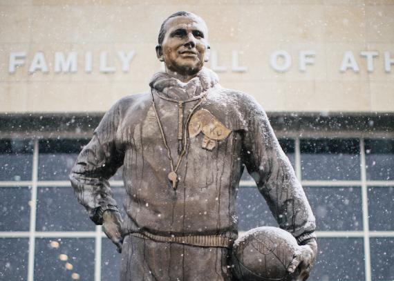 A dusting of snow on the Phog Allen statue with Booth Hall in the background